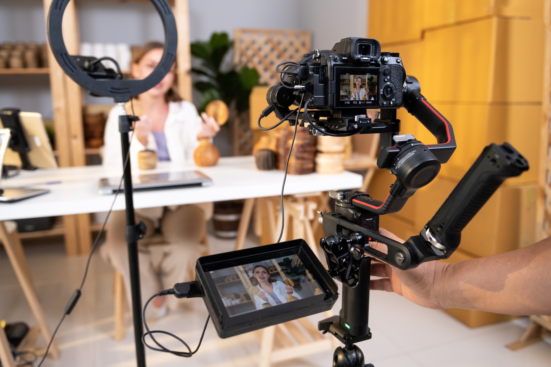 Behind the scenes of A young pretty woman entrepreneur live streaming to sale craft products to customers via filming professional camera Pro Photo